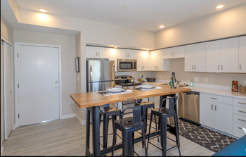 Stainless steel appliances including built-in microwave, refrigerator, and dishwasher